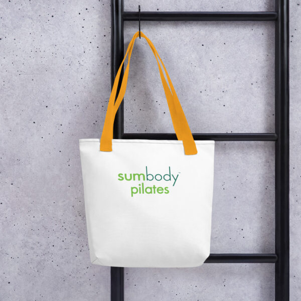White totebag with yellow handles and the Sumbody Pilates logo printed on.