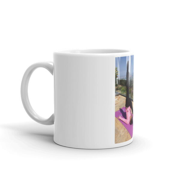 white glossy mug with photo of woman doing advanced pilates pose