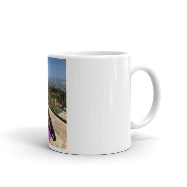 white glossy mug with photo of woman doing advanced pilates pose