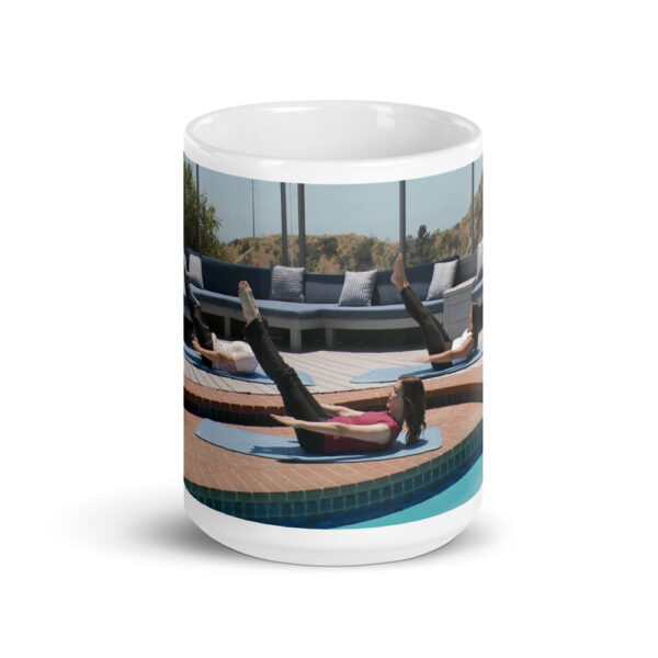 Glossy white mug with three people doing a pilates pose.