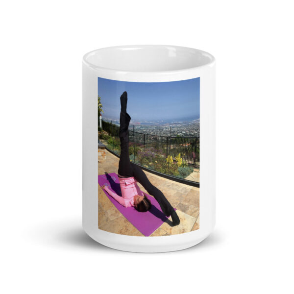 white glossy mug with photo of woman doing advanced pilates pose