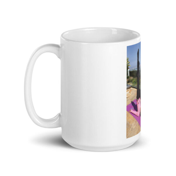 white glossy mug with photo of woman doing advanced pilates pose
