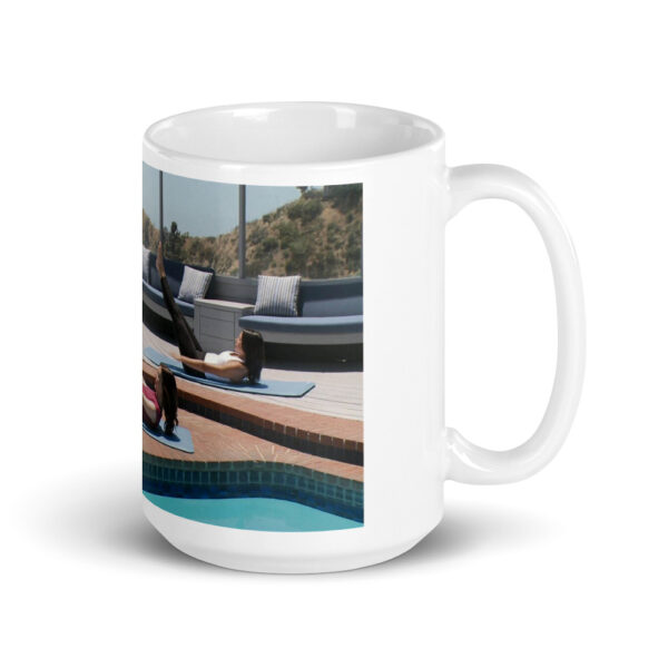 white glossy mug with people doing a pilates pose outdoors